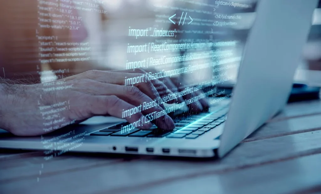 Hands typing on a laptop keyboard with transparent lines of computer code overlaid on the image