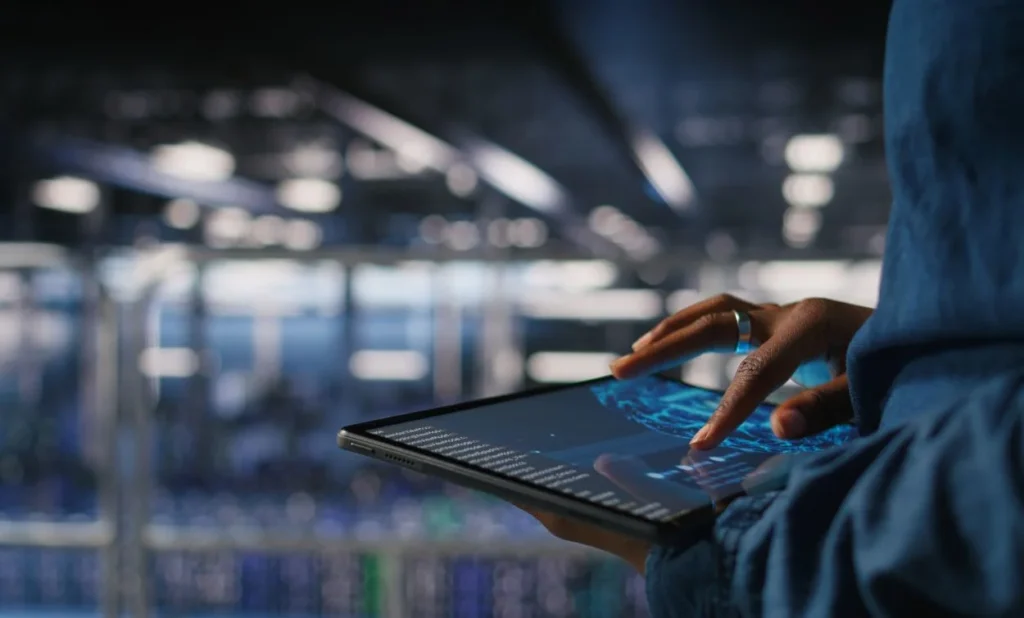 Professional working on a digital tablet in a modern IT environment, representing hands-on SAP training and enterprise technology solutions in Bangalore.