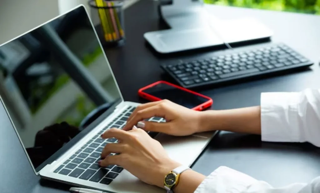 Student working on a laptop learning hardware and network concepts in a modern IT training environment